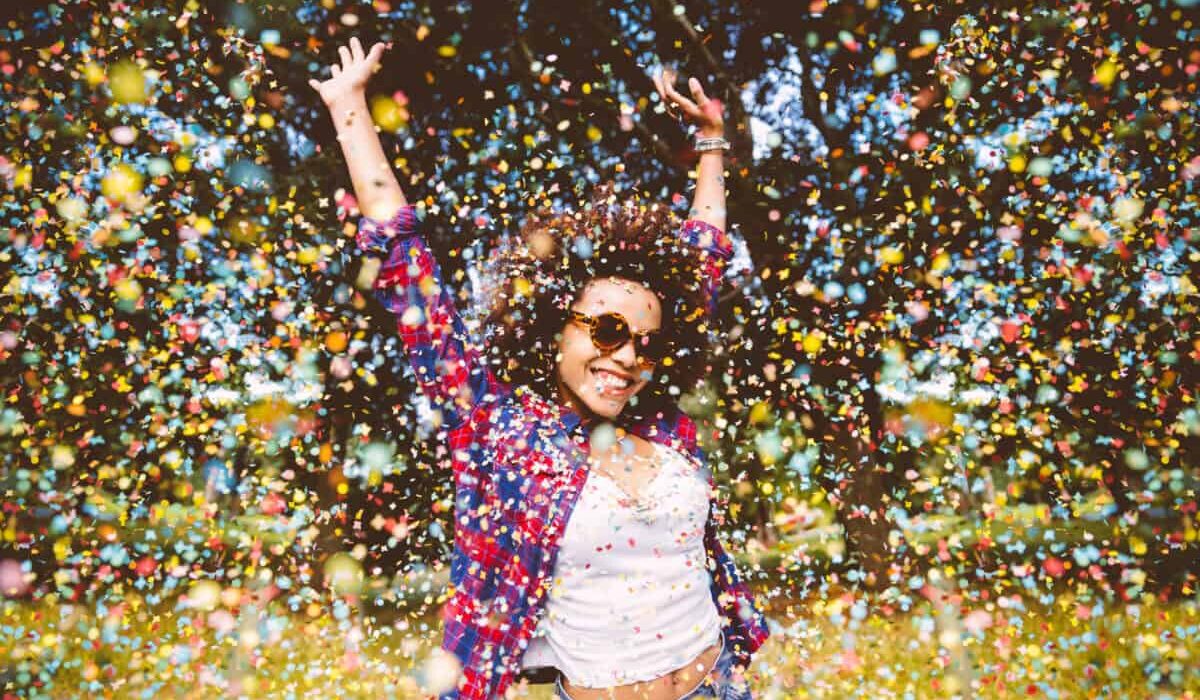 person enjoys shower of confetti outside