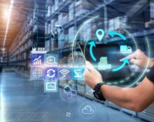 Person uses a tablet in a blurred warehouse as background