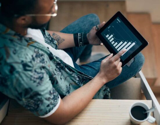 An investor uses a tablet