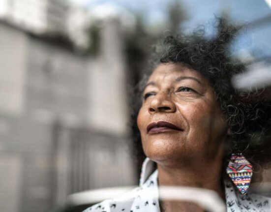 woman gazes forward out window to future
