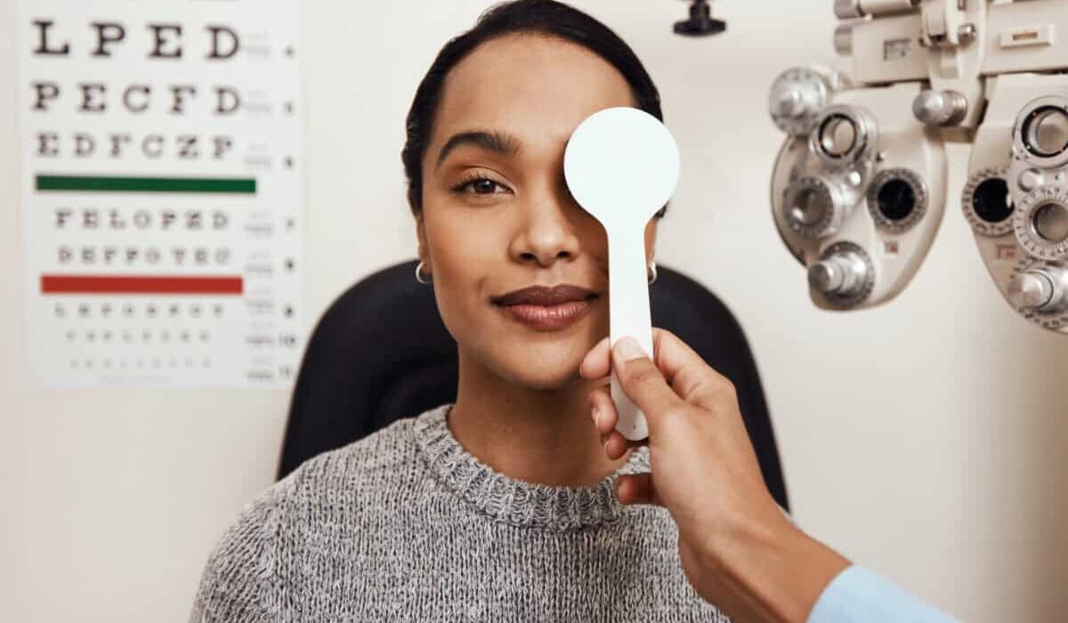 patient tests her eyes with a vision test at a doctor