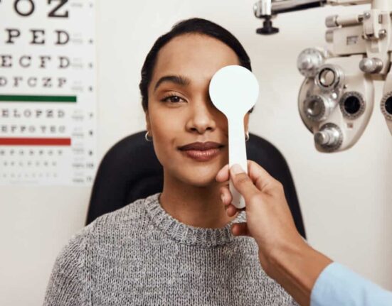 patient tests her eyes with a vision test at a doctor
